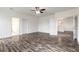 Spacious bedroom with ceiling fan, neutral paint, and wood-look flooring at 6808 Forkmead Ln, Port Orange, FL 32128
