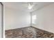 Simple bedroom with clean white walls, dark wood flooring, and a ceiling fan at 6808 Forkmead Ln, Port Orange, FL 32128