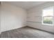 Clean bedroom featuring neutral walls, floating shelves, and a bright window at 6808 Forkmead Ln, Port Orange, FL 32128