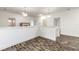 Hallway featuring hardwood floors and pendant lighting at 6808 Forkmead Ln, Port Orange, FL 32128
