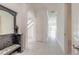 Bright hallway features tile floor and view into stairwell at 6808 Forkmead Ln, Port Orange, FL 32128