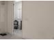 Hallway view features open doorway leading to sitting area with decorative chair and light gray floors at 6808 Forkmead Ln, Port Orange, FL 32128