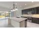 Modern kitchen with granite countertops, stainless steel appliances, and large island at 6808 Forkmead Ln, Port Orange, FL 32128