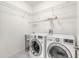 Bright laundry room with sink, LG washer and dryer, and wire shelving at 6808 Forkmead Ln, Port Orange, FL 32128