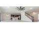 An open-concept living space boasts a modern kitchen and access to the staircase at 6808 Forkmead Ln, Port Orange, FL 32128