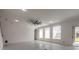 Bright living room with modern flooring, high ceilings, and multiple windows at 6808 Forkmead Ln, Port Orange, FL 32128