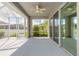 The screened patio has sliding doors and a ceiling fan providing shade and comfort at 6808 Forkmead Ln, Port Orange, FL 32128