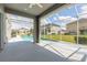Covered patio with screen enclosure features a partial view of a pool and backyard at 6808 Forkmead Ln, Port Orange, FL 32128