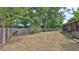 Dry grass backyard featuring a partial fence, foliage, and a portion of the home at 1119 Wild Oak Ter, Deland, FL 32720