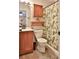 Bathroom with a wood vanity, toilet, and a shower-tub combo with a decorative curtain at 1119 Wild Oak Ter, Deland, FL 32720