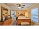 Cozy bedroom with a wooden bed, ceiling fan, and a window offering natural light at 1119 Wild Oak Ter, Deland, FL 32720