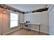 Bright bedroom used as an office featuring a long table and a unique decor at 1119 Wild Oak Ter, Deland, FL 32720
