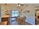 Sunlit dining area with backyard views, wood floors, and comfortable seating at 1119 Wild Oak Ter, Deland, FL 32720