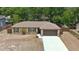 An aerial view of the home featuring a well-maintained lawn and neutral colored exterior at 1119 Wild Oak Ter, Deland, FL 32720