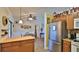 Open kitchen with stainless steel appliances, wood cabinets, and views of the dining area at 1119 Wild Oak Ter, Deland, FL 32720