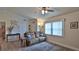 Cozy living room featuring a comfortable leather sofa, neutral walls, and a large window at 1119 Wild Oak Ter, Deland, FL 32720