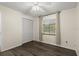 Bedroom with wood-look floors, closet, ceiling fan, and window with curtains at 126 Brandy Hills Dr, Port Orange, FL 32129