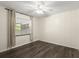 This bedroom features modern wood flooring and light colored walls. Large window dressed with matching curtains at 126 Brandy Hills Dr, Port Orange, FL 32129