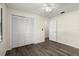 Bedroom with wood-look floors, closet, ceiling fan, and door to the next room at 126 Brandy Hills Dr, Port Orange, FL 32129