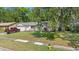 Charming single story home with verdant lawn, mature trees, gray paint and one car parking at 126 Brandy Hills Dr, Port Orange, FL 32129