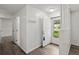 Bright foyer featuring a white front door, wood flooring, and a neutral color scheme at 126 Brandy Hills Dr, Port Orange, FL 32129