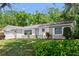 Charming single-story home featuring a well-maintained lawn, mature trees and an attached garage at 126 Brandy Hills Dr, Port Orange, FL 32129