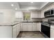 Bright kitchen boasts white cabinets, granite countertops, and stainless steel appliances at 126 Brandy Hills Dr, Port Orange, FL 32129