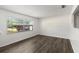 Bright living room featuring modern wood flooring and a large window at 126 Brandy Hills Dr, Port Orange, FL 32129