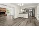 Spacious layout showcasing the kitchen, living room, and fireplace with modern flooring at 126 Brandy Hills Dr, Port Orange, FL 32129