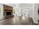 Living room with brick fireplace, neutral paint, modern flooring, and lots of light at 126 Brandy Hills Dr, Port Orange, FL 32129