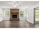 Cozy living room features a brick fireplace, modern flooring, and lots of natural light at 126 Brandy Hills Dr, Port Orange, FL 32129