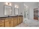 Modern bathroom with a walk-in shower and double vanity with wood cabinets at 1371 Melonie Trl, New Smyrna Beach, FL 32168