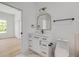 Bright bathroom featuring a white vanity, gold mirror, and black hardware at 1371 Melonie Trl, New Smyrna Beach, FL 32168