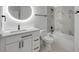 Bathroom with a vanity, backlit mirror, and walk-in shower with gray tile at 1371 Melonie Trl, New Smyrna Beach, FL 32168
