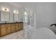 Modern bathroom features a glass walk-in shower, dual sinks, and a soaking tub at 1371 Melonie Trl, New Smyrna Beach, FL 32168