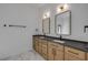Modern bathroom with double vanity, wood cabinets, and marble floors at 1371 Melonie Trl, New Smyrna Beach, FL 32168