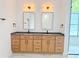 Bright bathroom featuring double vanity with modern fixtures and beautiful marble floors at 1371 Melonie Trl, New Smyrna Beach, FL 32168