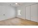 Clean bedroom with white walls, wood floors, ceiling fan, and closet doors at 1371 Melonie Trl, New Smyrna Beach, FL 32168