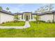 Charming single-story home featuring a well-manicured lawn and covered front porch at 1371 Melonie Trl, New Smyrna Beach, FL 32168