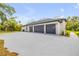 Spacious three-car garage with ample parking space and a clean, modern design at 1371 Melonie Trl, New Smyrna Beach, FL 32168