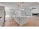 Bright open kitchen with large island, fireplace and stainless steel appliances at 1371 Melonie Trl, New Smyrna Beach, FL 32168