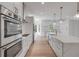 Bright kitchen featuring stainless appliances, a large island, and modern cabinetry at 1371 Melonie Trl, New Smyrna Beach, FL 32168