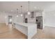Bright kitchen with an island, stainless steel appliances, and modern pendant lights at 1371 Melonie Trl, New Smyrna Beach, FL 32168