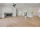 Open floor plan features a cozy fireplace, sleek hardwood flooring, and contemporary lighting at 1371 Melonie Trl, New Smyrna Beach, FL 32168