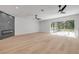 Living room with hardwood floors, ceiling fans, and a modern fireplace at 1371 Melonie Trl, New Smyrna Beach, FL 32168