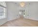 Bright living room with wood floors, arched windows, and a doorway leading to another room at 1371 Melonie Trl, New Smyrna Beach, FL 32168