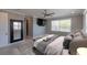 Bright bedroom features a ceiling fan, mounted television, large window, and decorative mirror at 1787 Earhart Ct, Port Orange, FL 32128