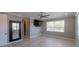 Bright bedroom features a ceiling fan, mounted television, large window, and walk-in closet at 1787 Earhart Ct, Port Orange, FL 32128