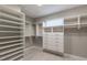 Custom walk-in closet with built-in shelving and drawers at 1787 Earhart Ct, Port Orange, FL 32128