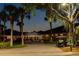 Exterior evening view of the Spruce Creek Country Club featuring well-lit entrance and landscaping at 1787 Earhart Ct, Port Orange, FL 32128